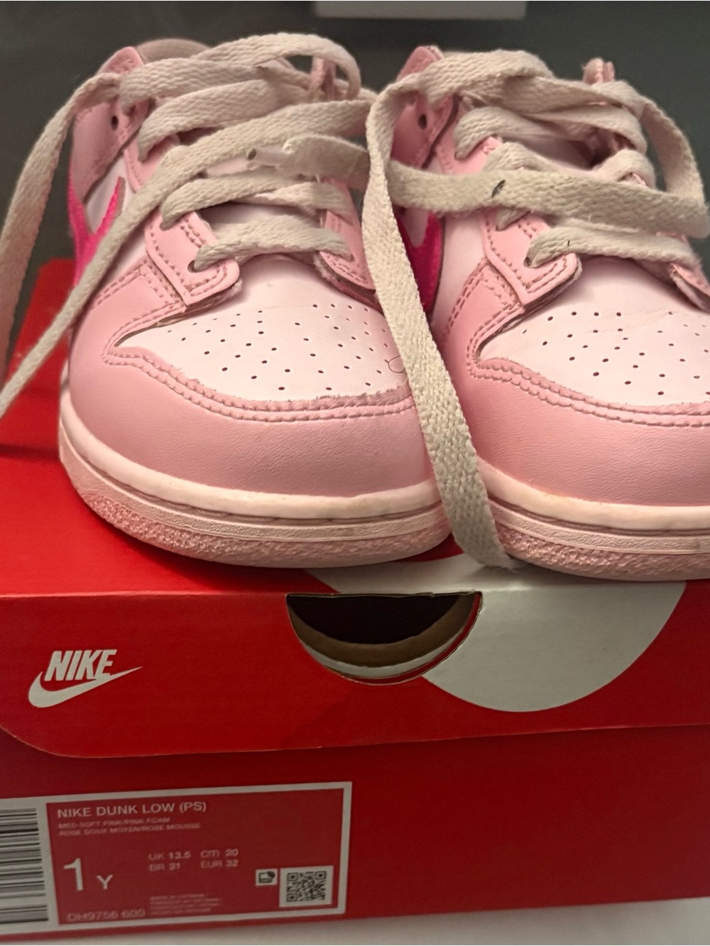 Nike Kids Pink Low-Top Sneakers with Light Gray Laces.